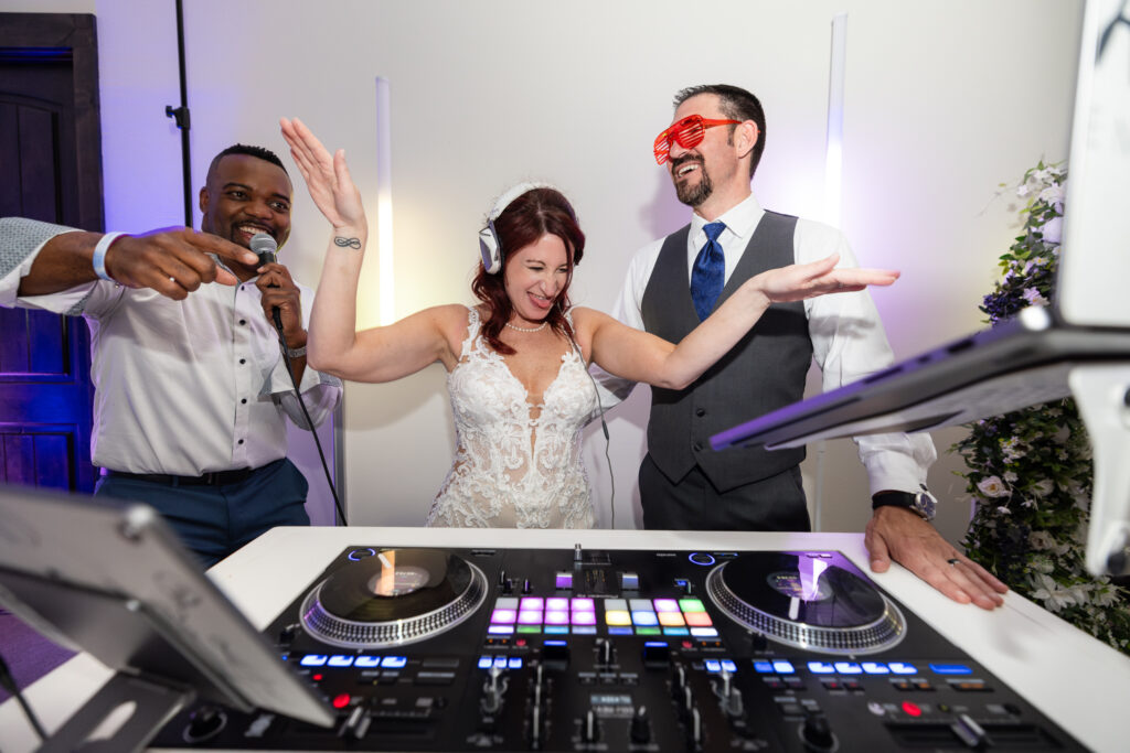 Bride and groom working DJ booth at Azle TX wedding venue with Arbutus Entertainment