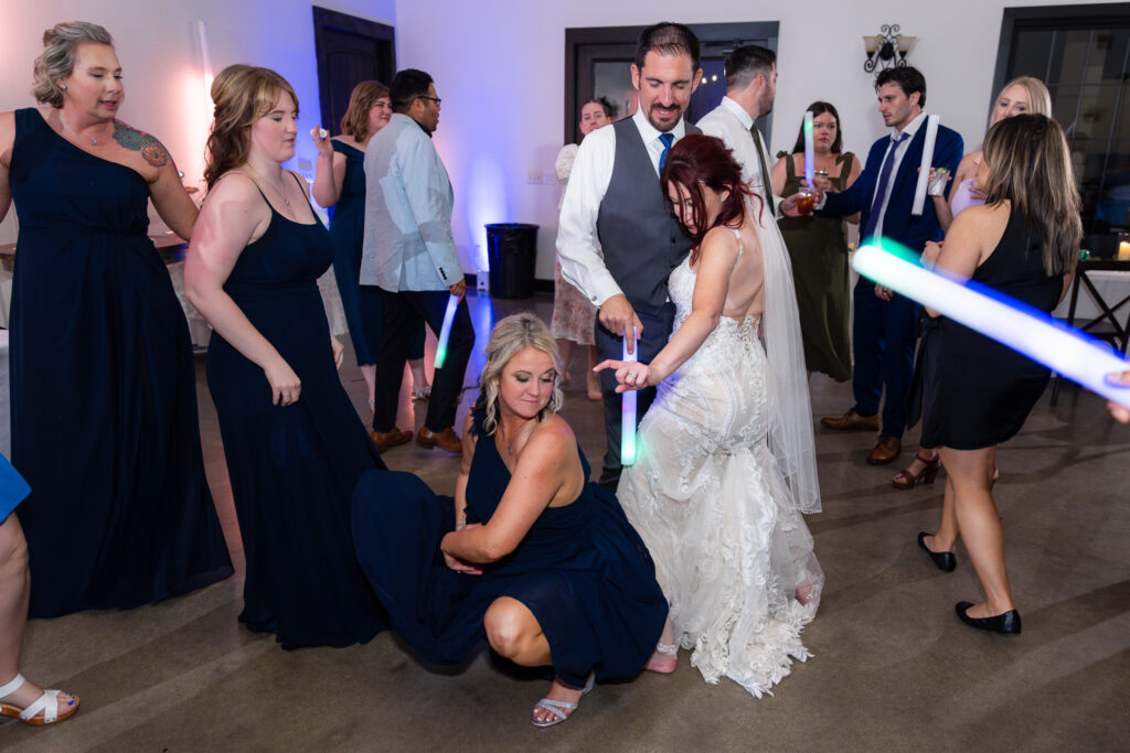 Bride dancing with bridesmaids and groom on dance floor