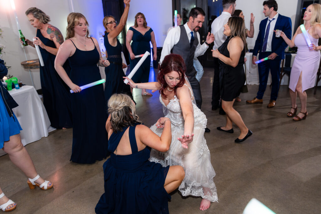 Bride dancing with bridesmaids on dance floor