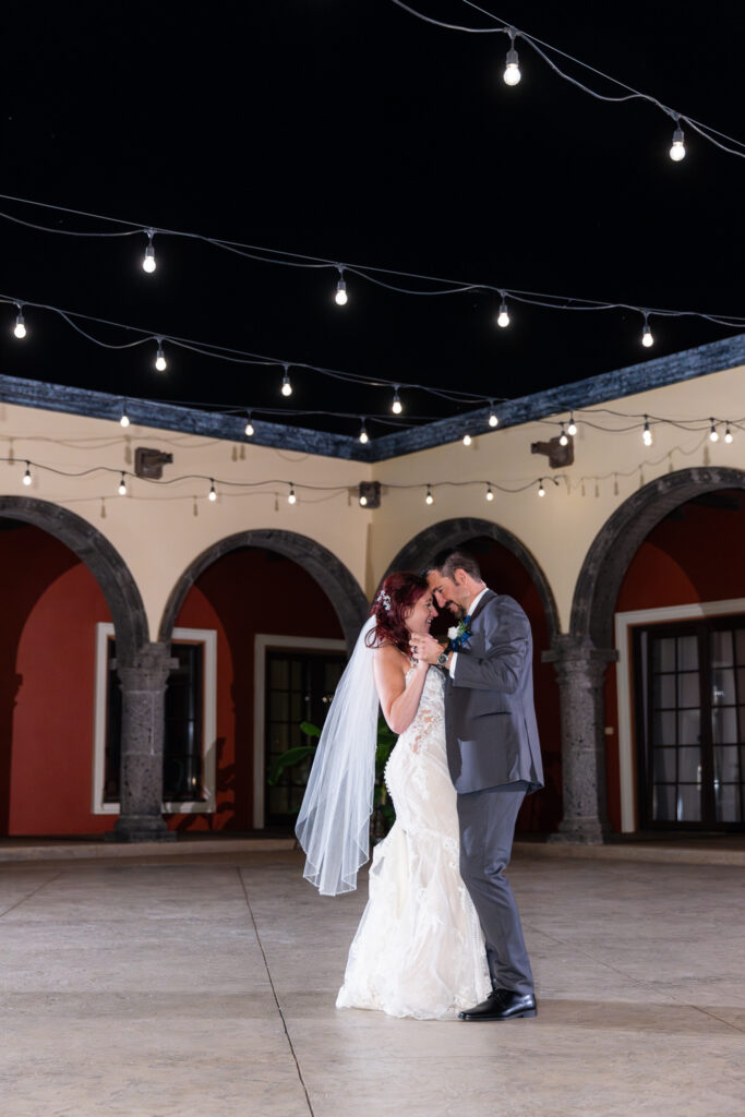 Bride and groom dancing intimately during private last dance in courtyard of Stoney Ridge Villa wedding venue