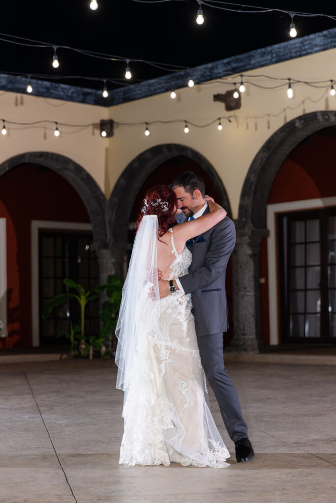 Bride and groom dancing intimately during private last dance in courtyard of Azle TX wedding villa