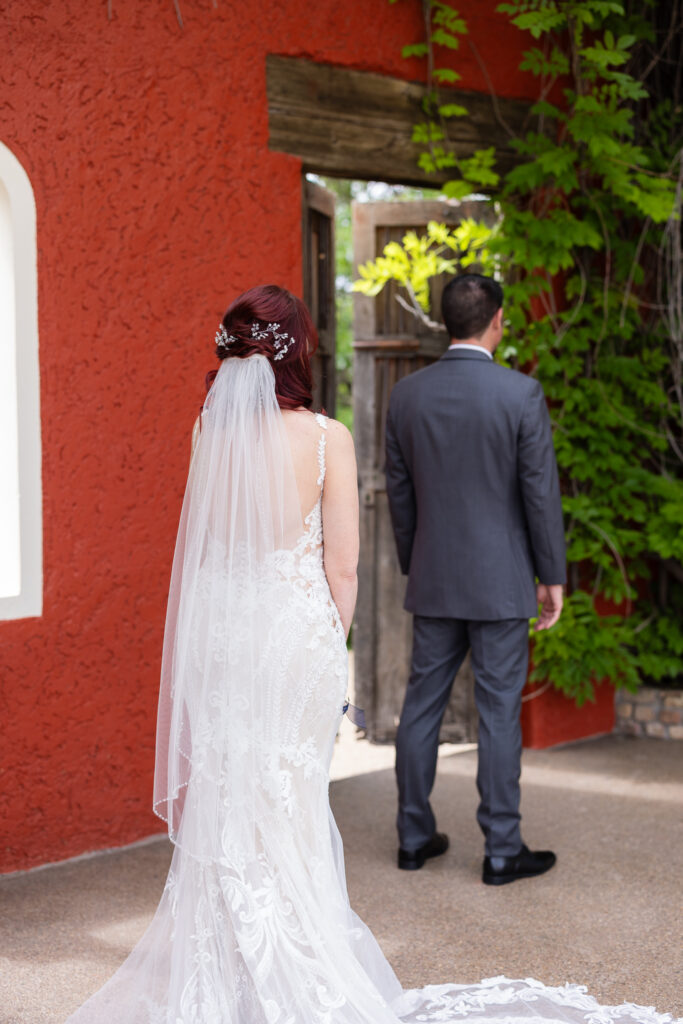 Bride waiting for groom to turn around and see her for the first look