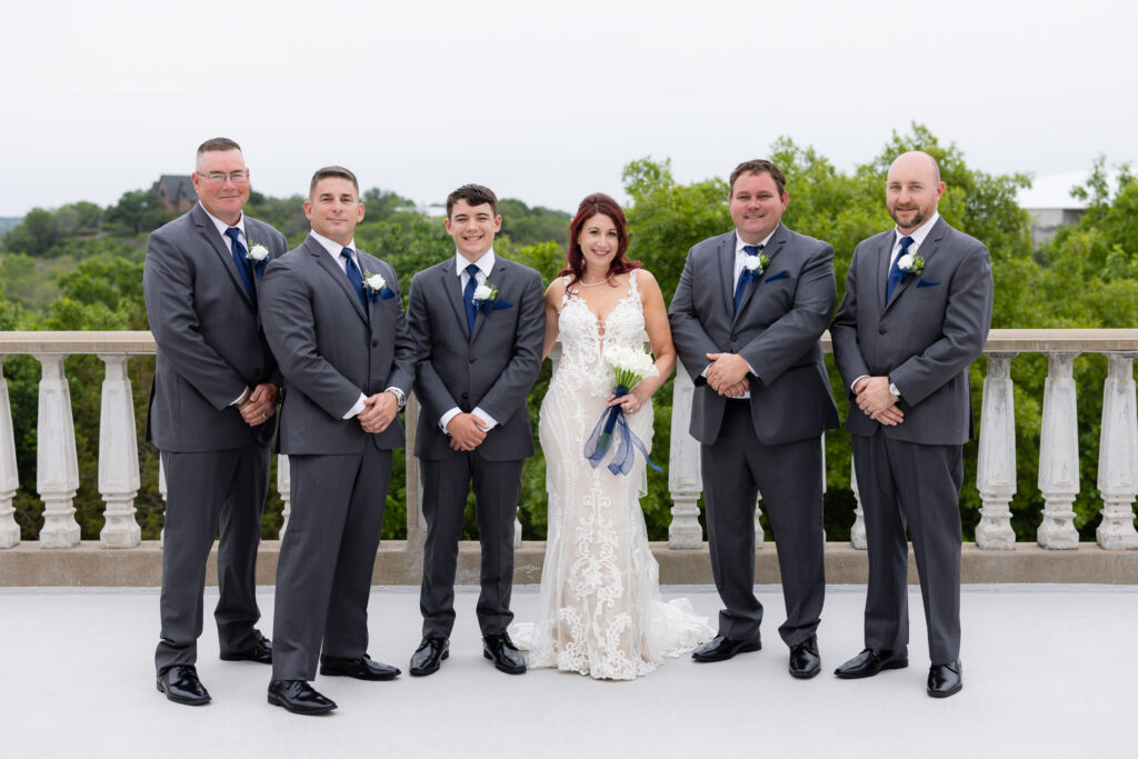 Bride with groomsmen in grey suits and blue ties