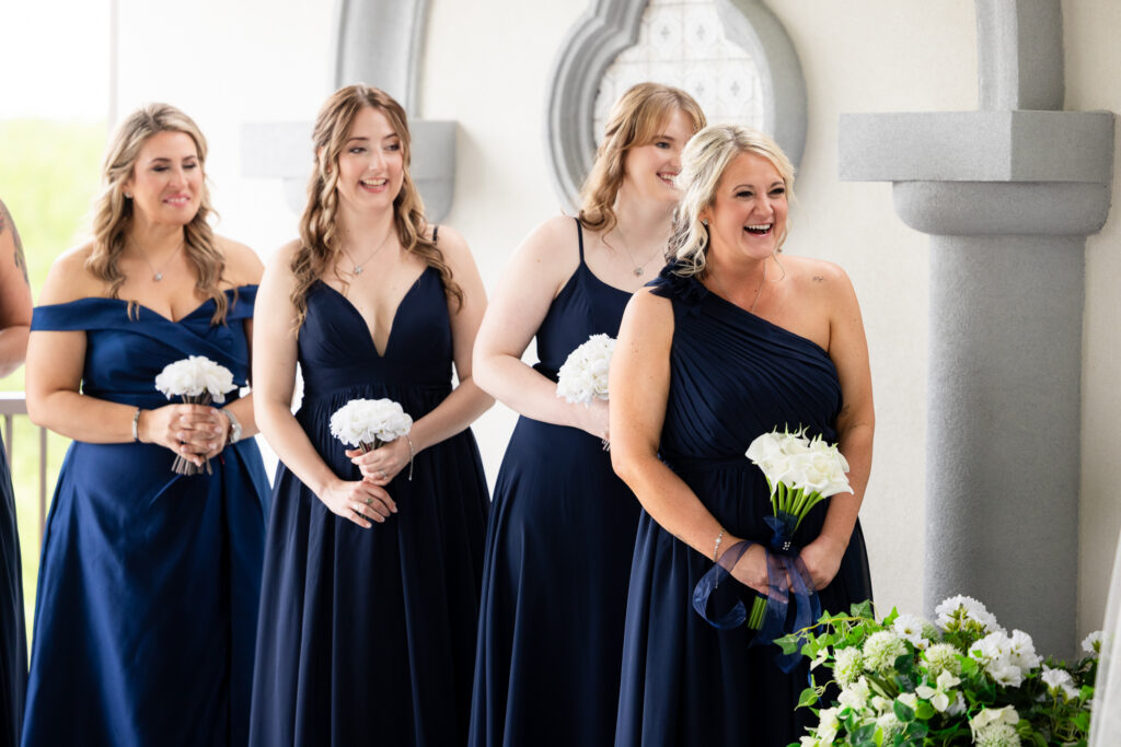 Bridesmaids laughing during ceremony