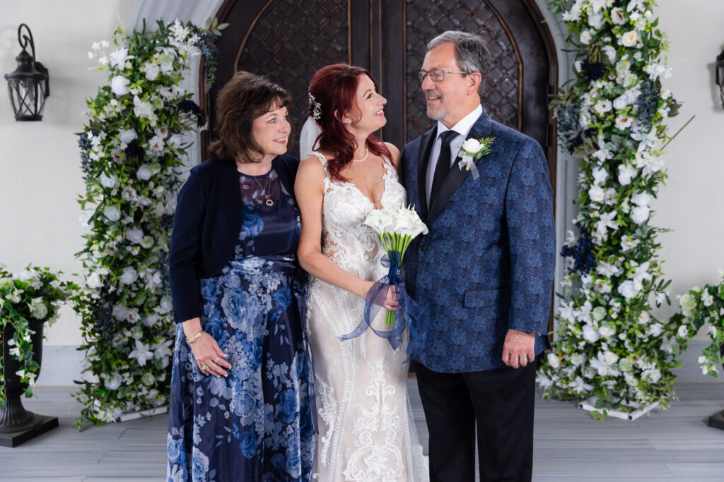 Bride with mom and dad smiling