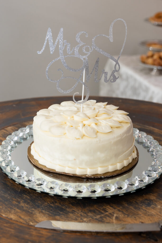 Simple and elegant white wedding cake with Mr & Mrs cake topper