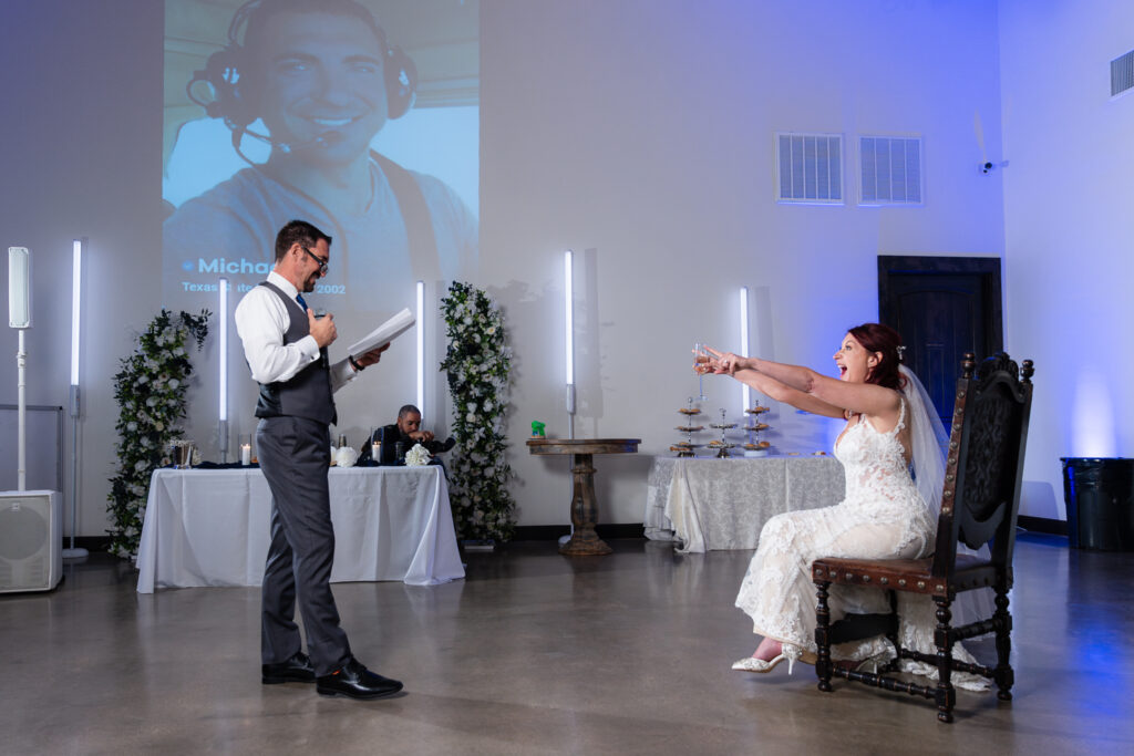 Bride laughing at groom during speech at wedding reception