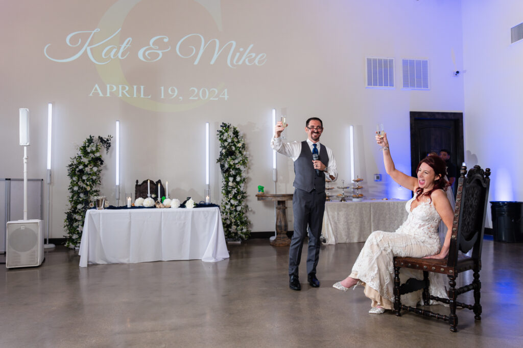 Bride and groom toasting after groom's speech during wedding reception