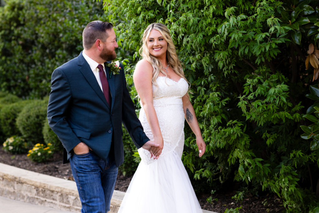 Wedding couple walking and smiling at each other