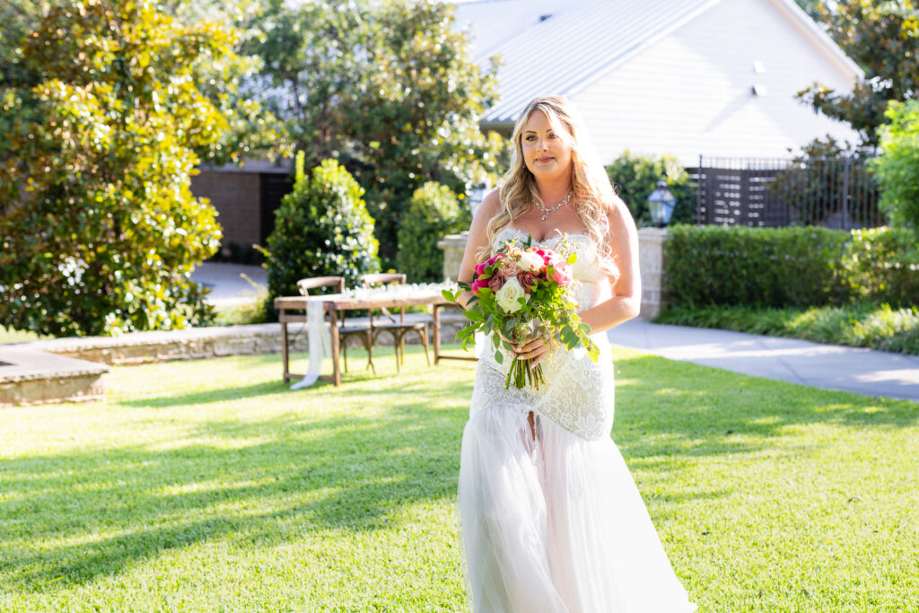 Bride walking across lawn before wedding ceremony