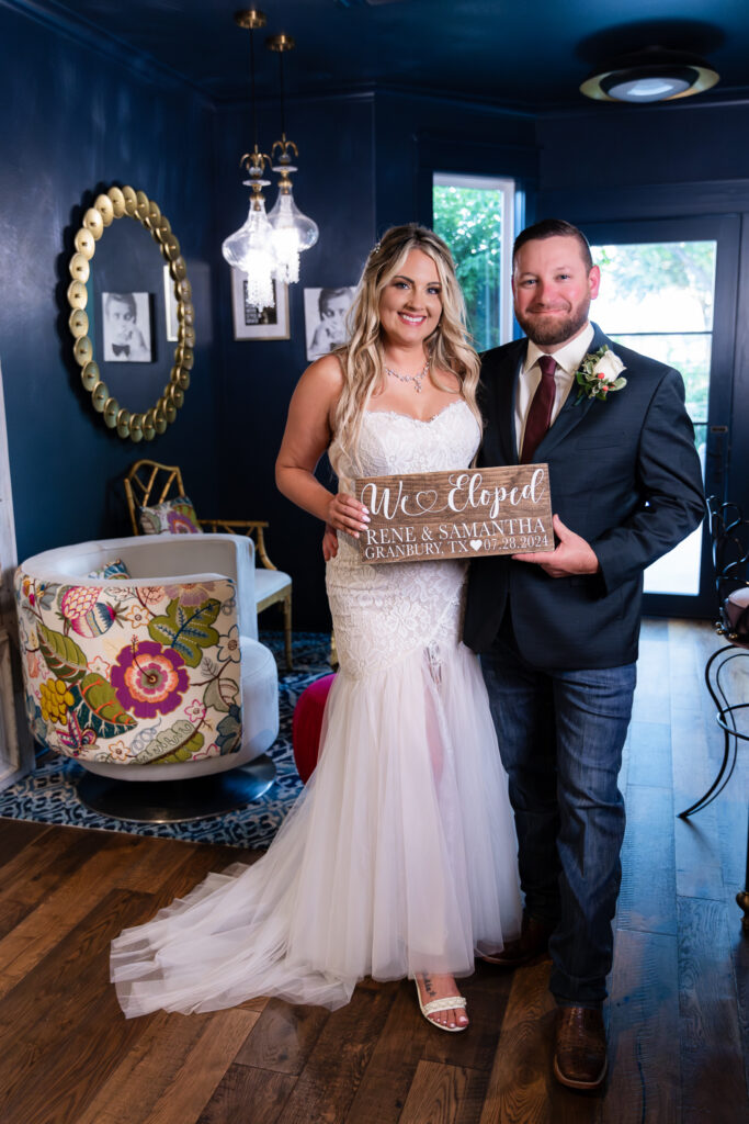 Bride and groom standing inside chic blue hotel bar in Granbury TX