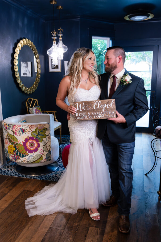 Bride and groom standing inside chic blue hotel bar in Granbury Texas