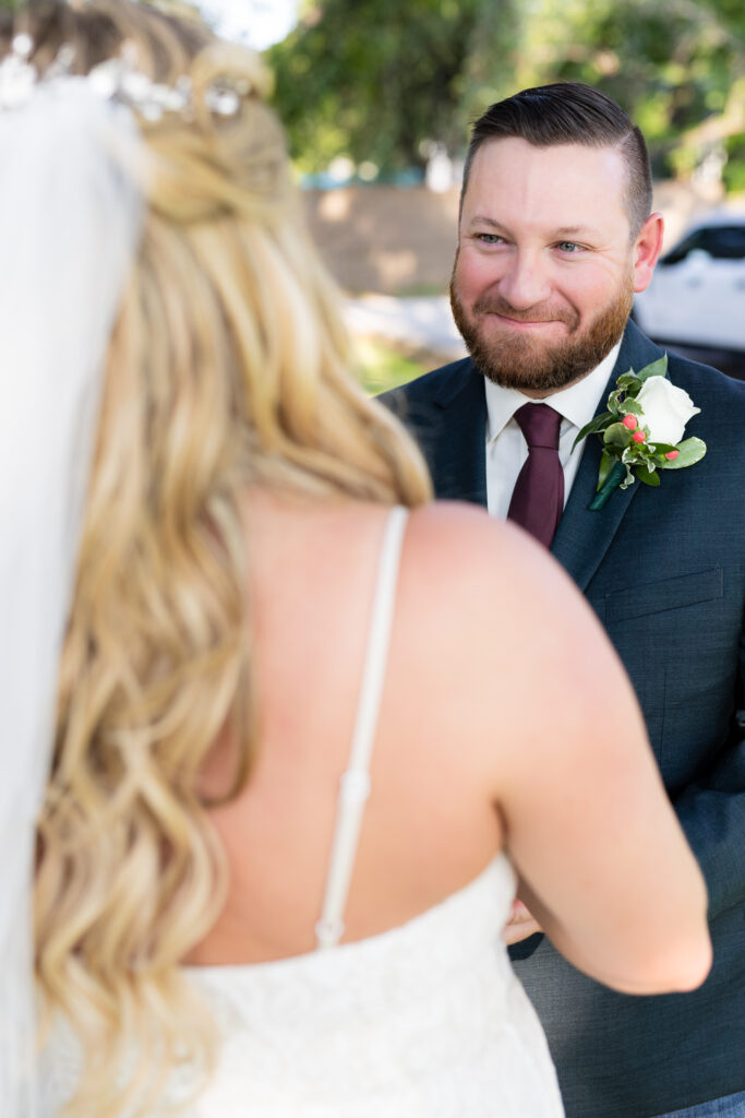 Groom smiling at bride during elopement wedding ceremony