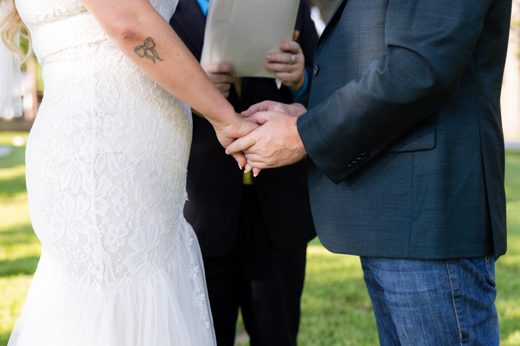 Bride and groom holding hands during wedding ceremony