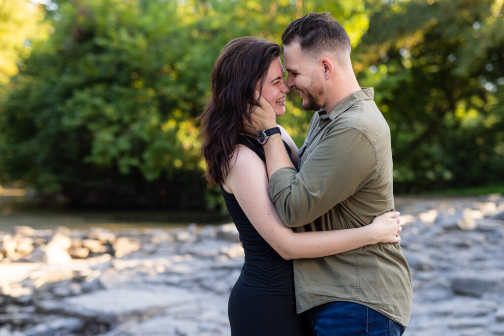 Engaged couple intimately laughing while hugging during romantic Richardson Park engagement session