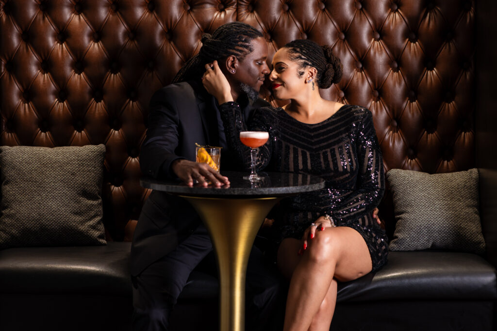 Man and woman sitting intimately together at a cocktail table