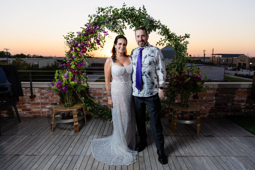 bride in a Galia Lahav Oriana sparkling a-line wedding dress standing with groom on rooftop at Prosper Wine House at sunset