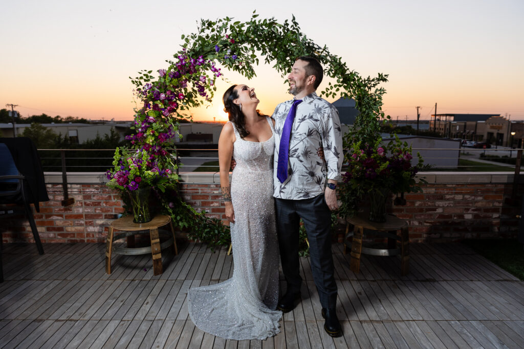 bride in a Galia Lahav Oriana sparkling a-line wedding dress laughing with groom on rooftop at Prosper Wine House at sunset