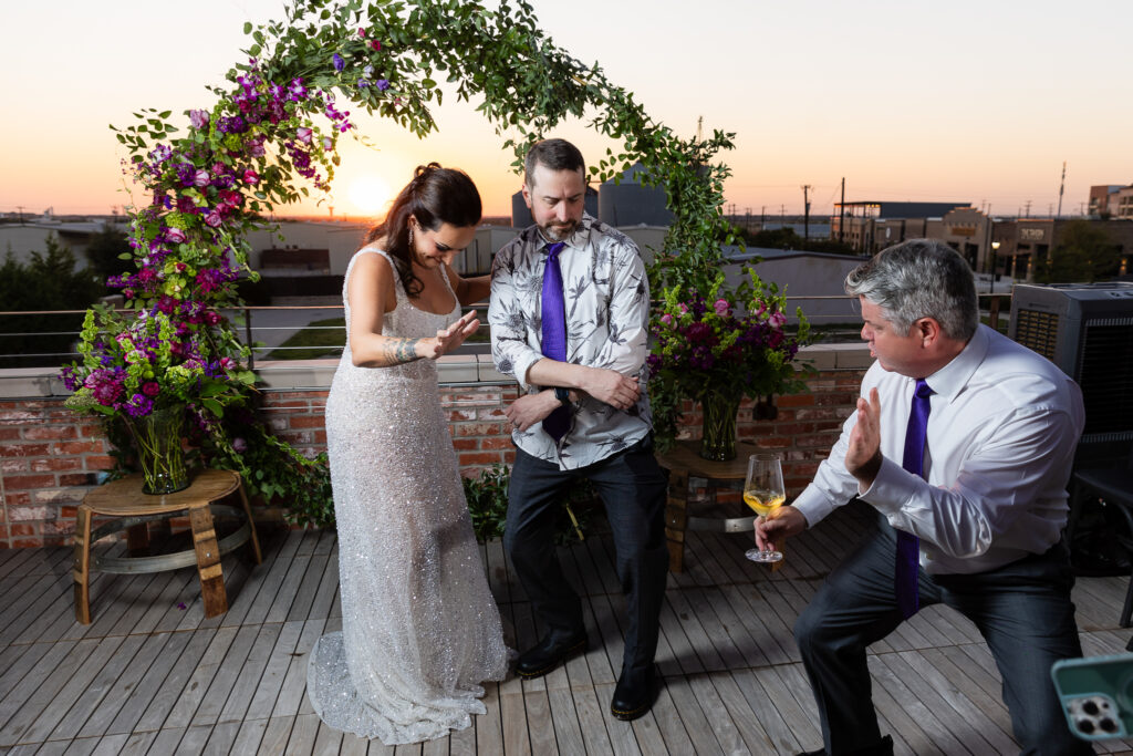 bride, groom and best man dancing on Prosper Wine House rooftop at sunset