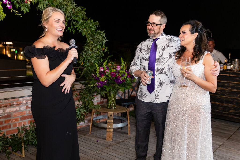 maid of honor giving funny speech during rooftop wedding reception