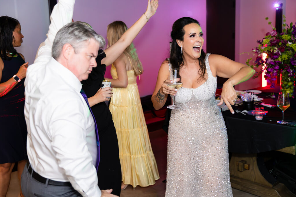 bride and friends dancing on dance floor during wedding reception