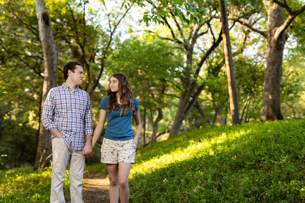 engaged couple strolling through Prather Park during engagement session