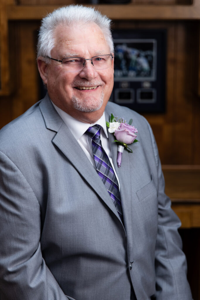 portrait of groom smiling at The Abbey wedding venue