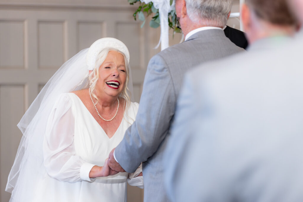 bride laughing during 50th wedding anniversary vow renewal at The Abbey