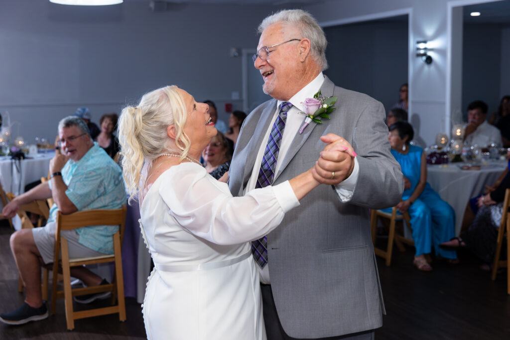 elderly bride and groom singing and dancing during reception for 50th vow renewal at The Abbey