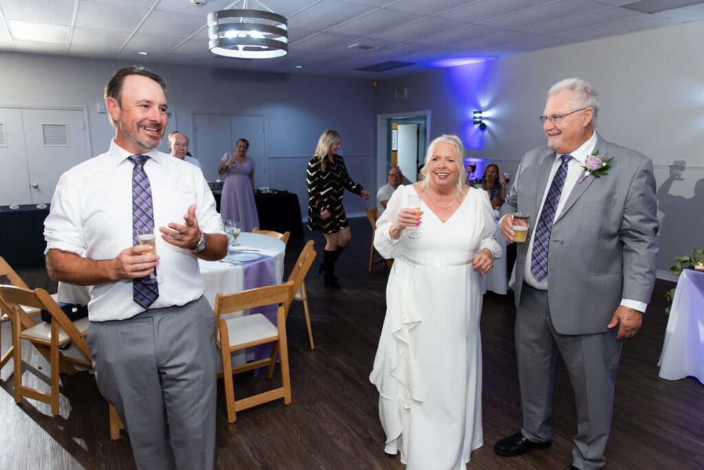 son giving speech to bride and groom in the reception hall at The Abbey