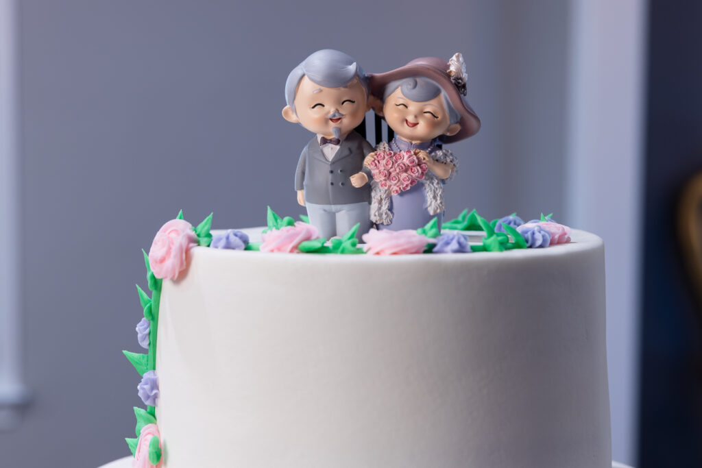 cute cartoon cake topper of happy elderly couple