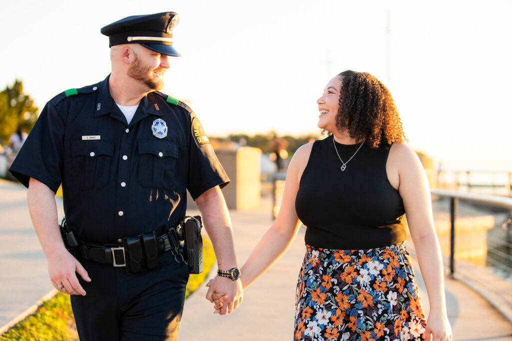 engaged couple holding hands while laughing during Rockwall engagement session