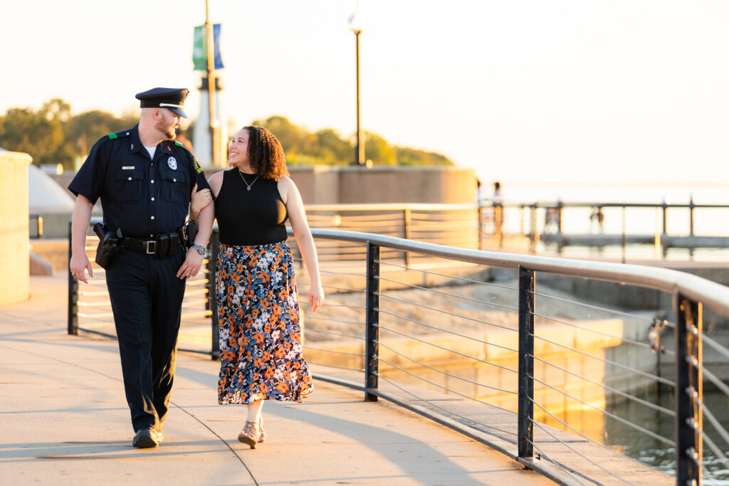 engaged couple walking along lake in Rockwall