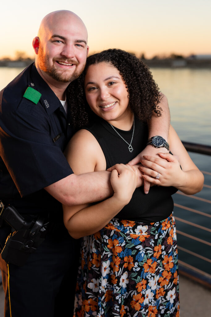 engaged man hugging fiancée from behind at Rockwall lake engagement