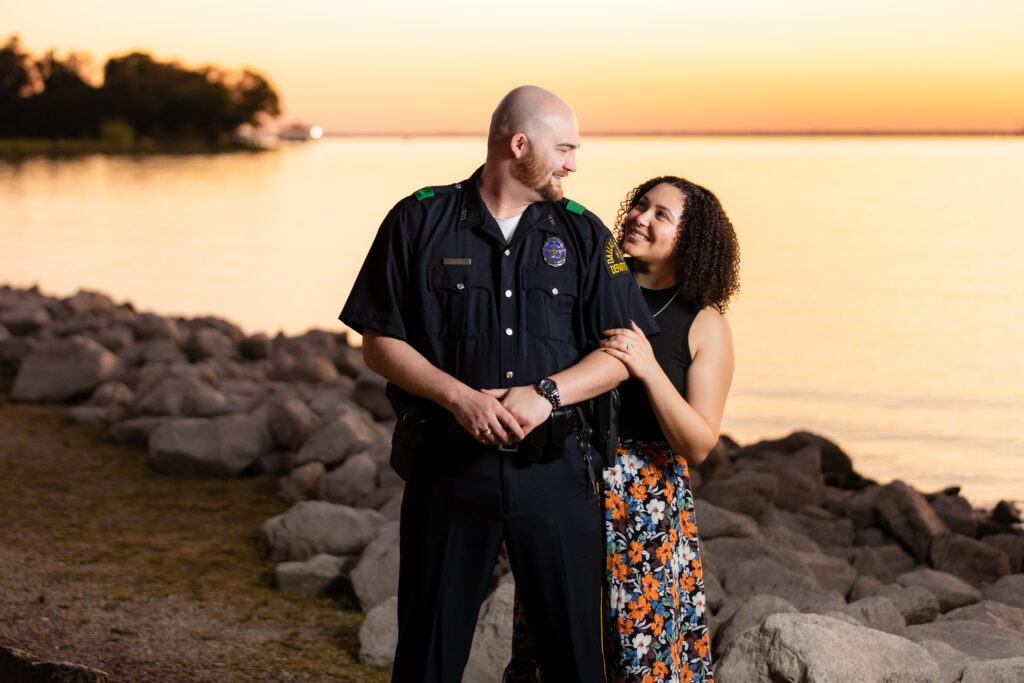 engaged couple smiling at each other on Rockwall lake during engagement shoot