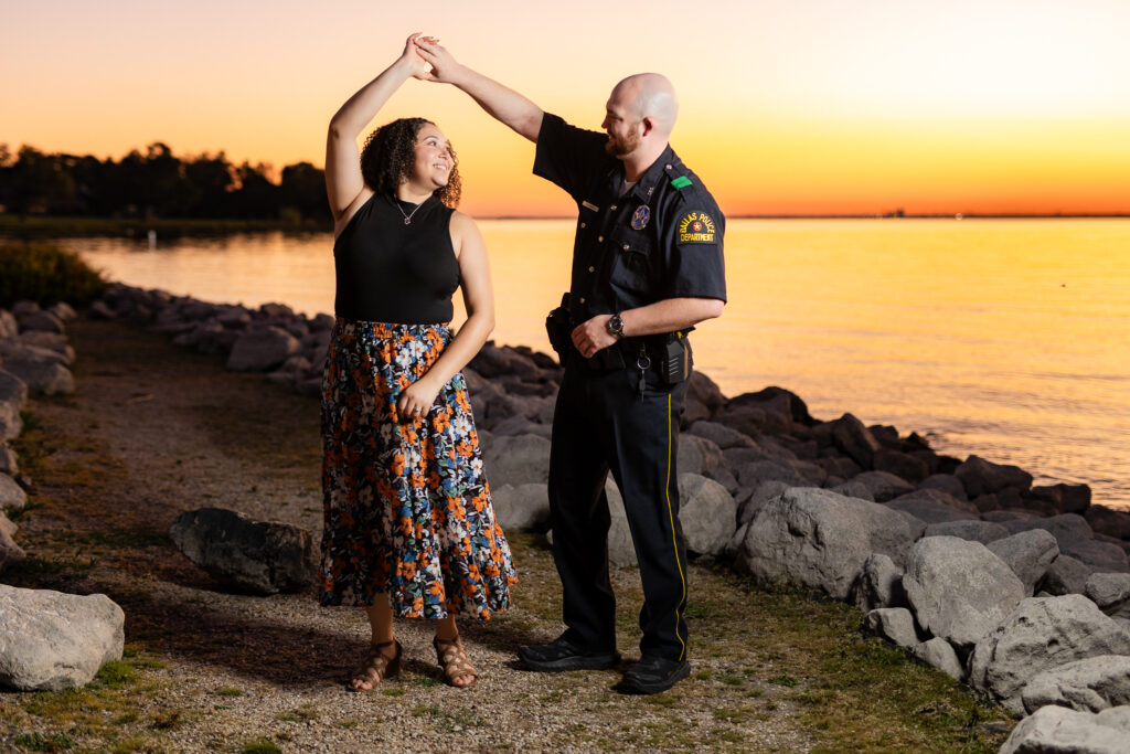 engaged couple dancing at sunset by Rockwall lake during engagement session