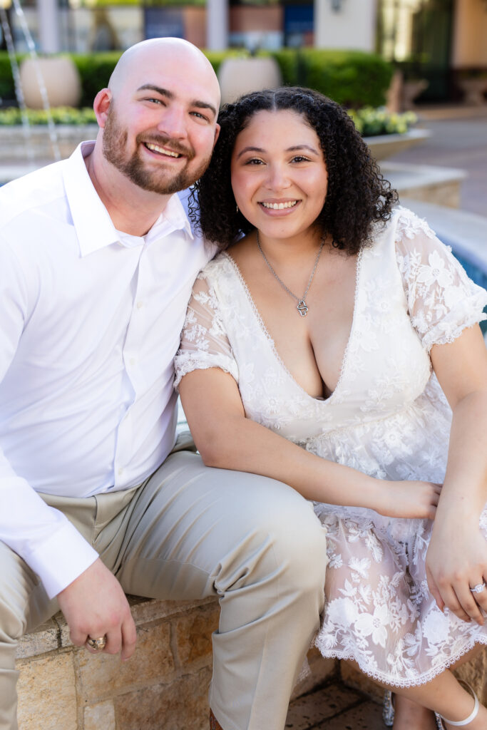 engaged couple in all white smiling and leaning head to head during Rockwall engagement session