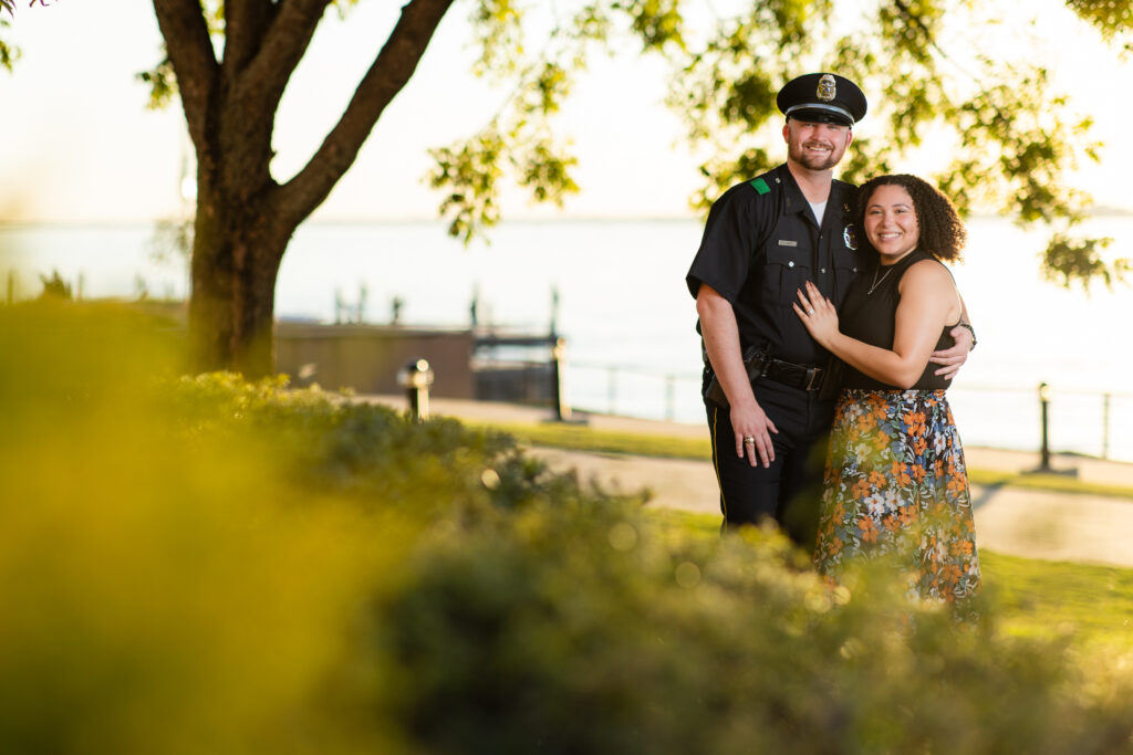 engaged couple under tree smiling in Rockwall TX